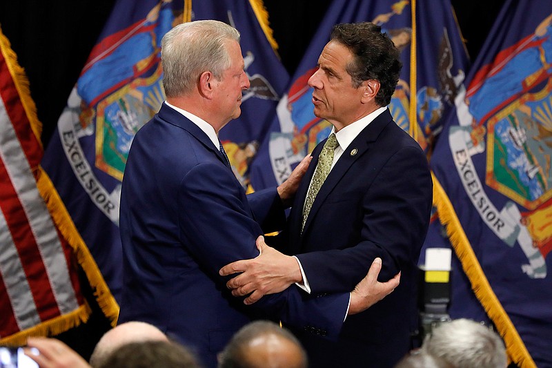 New York Gov. Andrew Cuomo, right, talks with former Vice President Al Gore after signing the Climate Leadership and Community Protection Act on Thursday, July 18, 2019, at Fordham University in New York.
