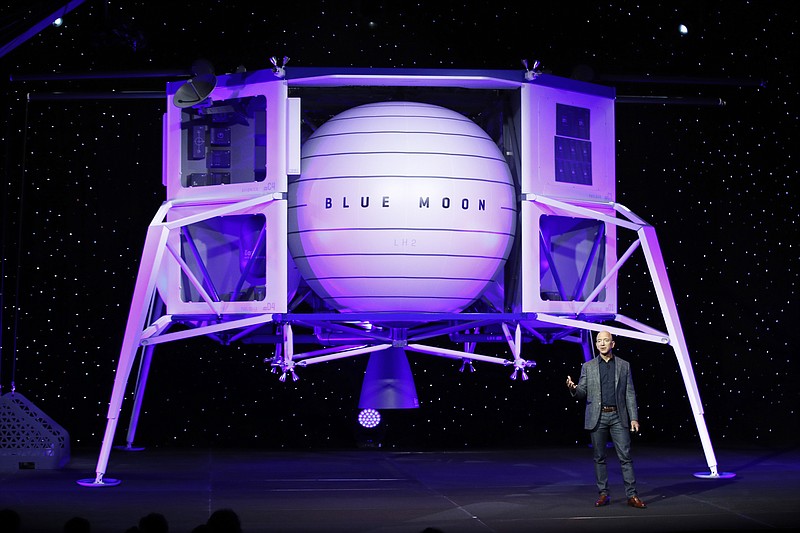 FILE - In this, May 9, 2019, file photo, Jeff Bezos speaks in front of a model of Blue Origin's Blue Moon lunar lander in Washington. Bezos and Virgin Galactic's Richard Branson favor going back to the moon before Mars. SpaceX's Elon Musk also is rooting for the moon, although his heart's on Mars. (AP Photo/Patrick Semansky, File)