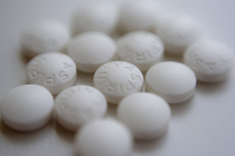 This Thursday, Aug. 23, 2018 file photo shows an arrangement of aspirin pills in New York. A new study suggests millions of people need to rethink their use of aspirin to prevent a heart attack. If you've already had a heart attack, doctors recommend taking a low-dose aspirin a day to prevent a second one. But if you don't yet have heart disease, doctors now advise routine aspirin can do more harm than good.