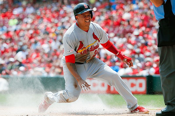 Yairo Munoz of the Cardinals pops up after scoring a run during the second inning of Sunday afternoon's game against the Reds in Cincinnati.