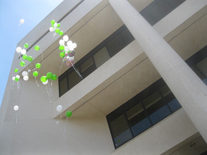 Friends and family members release white and green helium balloons Sunday, July 21, 2019, in front of the Bi-State Justice Building jail in Downtown Texarkana to memorialize the third anniversary of Morgan Angerbauer's death.  This month would have been her 24th birthday. 