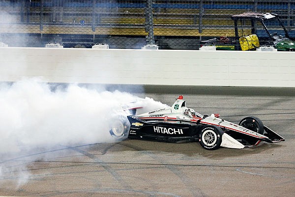 Josef Newgarden does a burnout Sunday morning after winning the IndyCar Series race at Iowa Speedway in Newton, Iowa.
