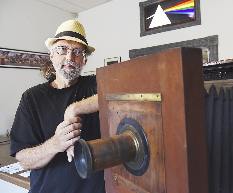 Lloyd Grotjan poses next to a 10-inch view camera in his downtown Jefferson City photographic studio, Full Spectrum Photo. Grotjan is a man of many talents including professional photographer, musician and visual artist.