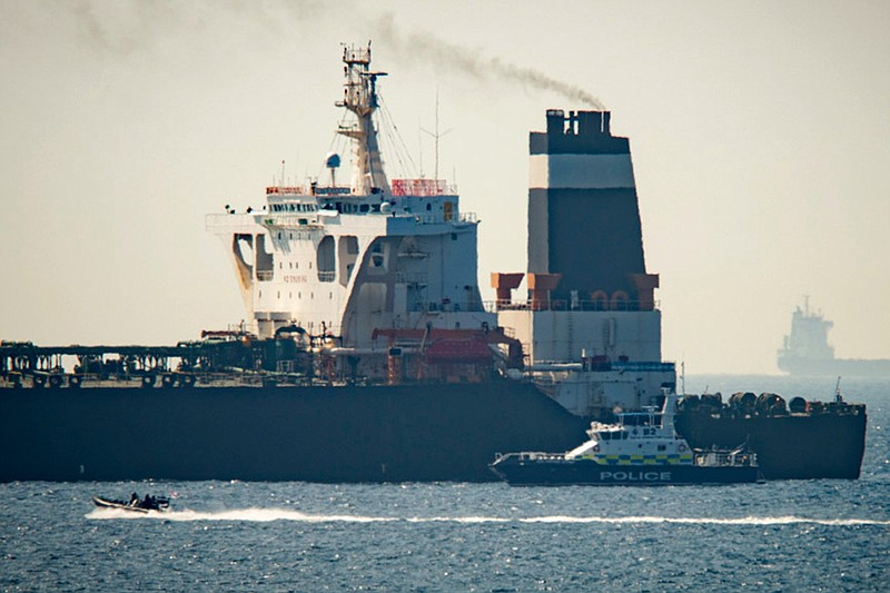 In this Thursday, July 4, 2019 file photo, a Royal Marine patrol vessel is seen beside the Grace 1 super tanker in the British territory of Gibraltar. Taken on its own, Iran's seizure of a British-flagged oil tanker in the Strait of Hormuz may seem like a brazen act of aggression, a provocative poke in the nose to both Britain and its chief ally, the United States. But Iran seems to view the armed takeover of the Stena Impero as a carefully calibrated response to the July 4 taking of an Iranian supertanker off the coast of Gibraltar, an operation in which Britain's Royal Marines played a major role. (AP Photo/Marcos Moreno, File)