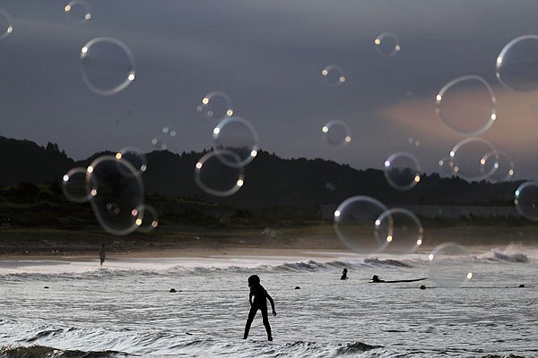 Soap bubbles fly as a boy rides a wave last week at Taito Beach located next to Tsurigasaki, a venue for surfing at the Tokyo 2020 Olympics, in Isumi, Chiba prefecture, east of Tokyo. As one of five new sports being added to the program for 2020 Tokyo Olympics, surfing is arguably the most glamorous and is sure to bring a new dimension as the IOC seeks a younger audience.
