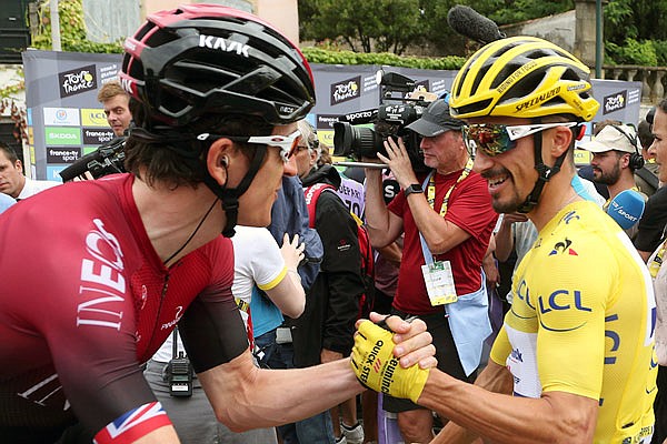 Defending champion Geraint Thomas shakes hands with Tour leader Julian Alaphilippe prior to Sunday's 15th stage.