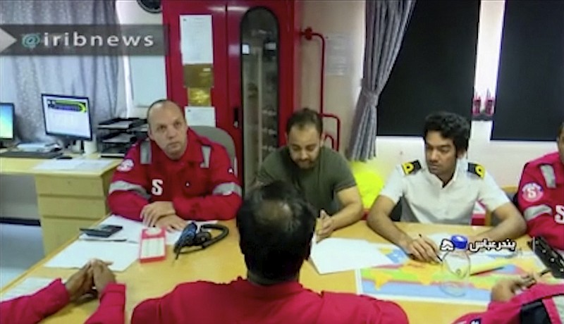 In this photo released by state-run IRIB News Agency, which aired on Monday, July 22, 2019, shows various crew members of the British-flagged tanker Stena Impero, that was seized by Tehran in the Strait of Hormuz on Friday, during a meeting. The Associated Press cannot independently verify the condition of the crew members, but in the video they looked to be in good health and it didn't appear as though they were being filmed under duress. (IRIB News Agency via AP)