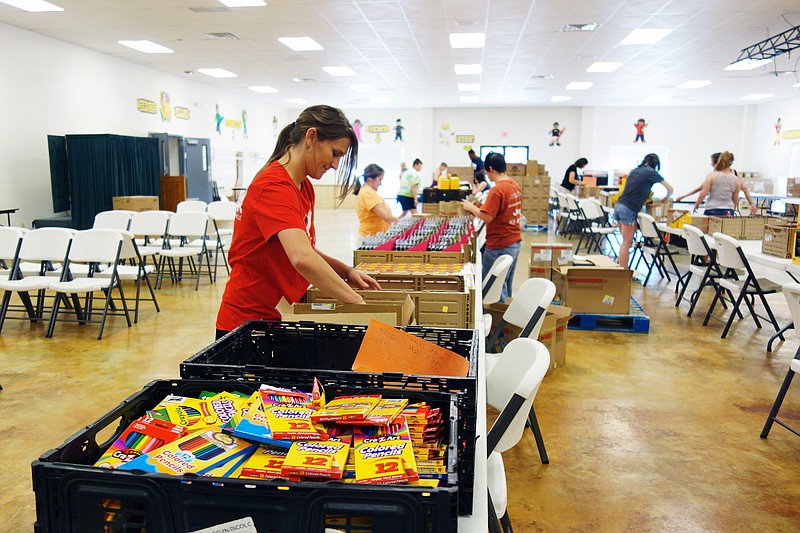 <p>Helen Wilbers/For the News Tribune</p><p>Volunteer Jessica Rost, of Springfield, prepares bins of school supplies for Saturday’s SERVE Back to School Fair. The free annual event is 9 a.m.-2 p.m. at Callaway Christian Church in Fulton.</p>