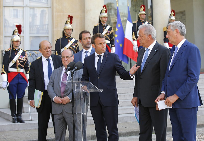From left to right, French Foreign Minister Jean-Yves Le Drian, Director of the United Nations Migration Agency Antonio Manuel de Carvalho Ferreira Vitorino, French Interior Minister Christophe Castaner, French President Emmanuel Macron, European Commissioner for Migration and Home Affairs Dimitris Avramopoulos and United Nations High Commissioner for Refugees (UNHCR) Filippo Grandi meet the media after a meeting at the Elysee Palace in Paris, France, Monday, July 22, 2019. European ministers have met in Paris seeking unity on how to deal with migrants crossing the Mediterranean Sea. (AP Photo/Michel Euler)
