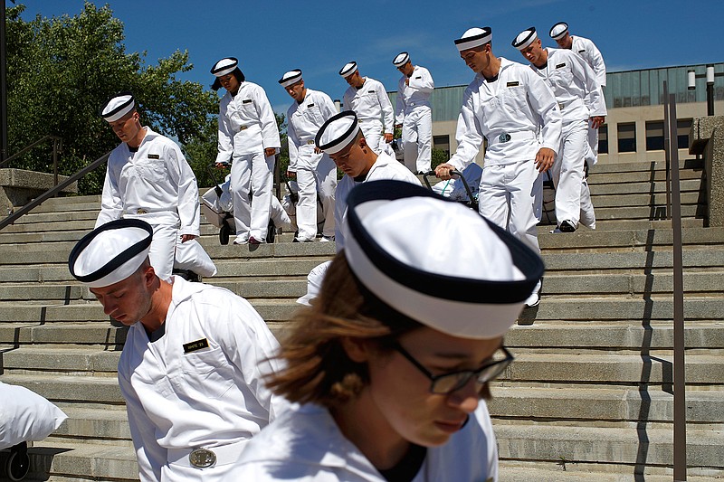 In this June 27, 2019, file photo, incoming plebes carry their belongings down a staircase during Induction Day at the U.S. Naval Academy, in Annapolis, Md. An analysis released Tuesday, July 23, 2019, shows the percentage of female students nominated by members of Congress for admission to U.S. service academies has been rising although men are still put forward at numbers nearly three times higher than women. (AP Photo/Patrick Semansky, File)
