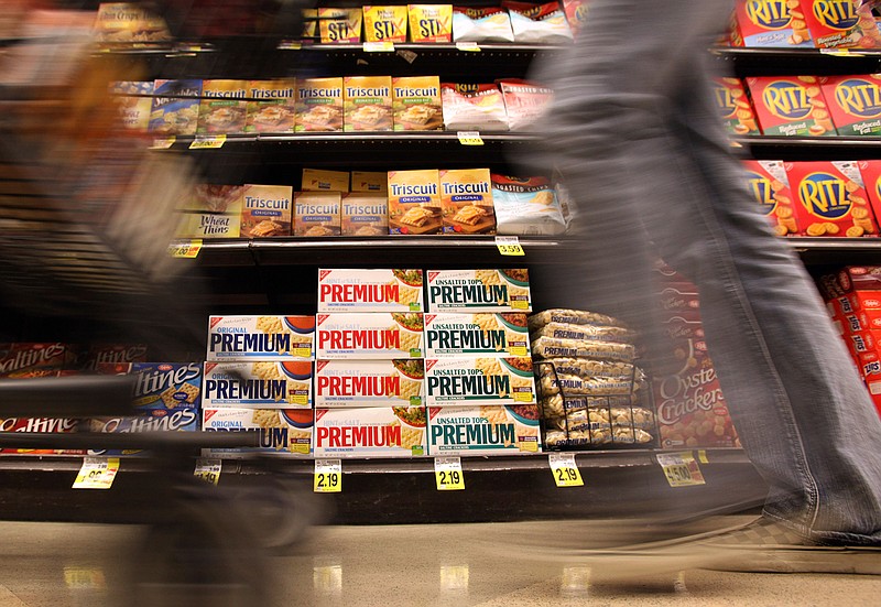 In this Feb. 9, 2011, file photo, a shopper passes a shelf of crackers and other items at a Ralphs Fresh Fare supermarket in Los Angeles. The supermarket is one of the most important places to be shopping-savvy. The good news is that there are so many easy and effective way to slash your grocery budget. (AP Photo, File)