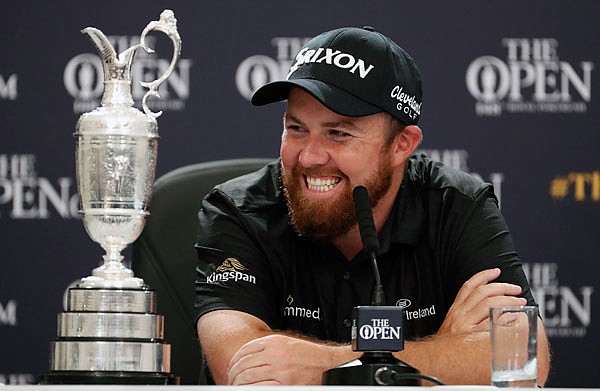 Shane Lowry smiles as he sits next to the Claret Jug at a press conference Sunday at Royal Portrush in Northern Ireland.