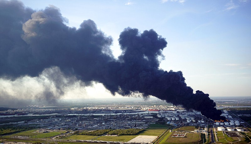 In this March 18, 2019 file photo, a plume of smoke rises from a petrochemical fire at the Intercontinental Terminals Company in Deer Park, Texas. It's been four months since the explosion and fire at a Houston-area petrochemical storage site and experts are still working to dispose of millions of gallons of waste and contaminated water. The Houston Chronicle reports Intercontinental Terminals Company must comply with a 31-page management plan that details how waste is sampled and identified, stored and finally disposed of. More than 21 million gallons of water mixed with product and firefighting foam were collected from the tank farm and Houston Ship Channel following the March 17 accident that triggered air quality warnings. 