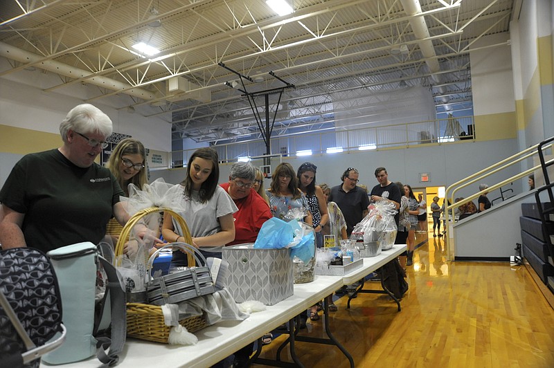 Guests at the annual Piccadilly bid on silent auction items Friday, July 19, 2019. The fundraiser supports the Moniteau Christian Ministries Center.