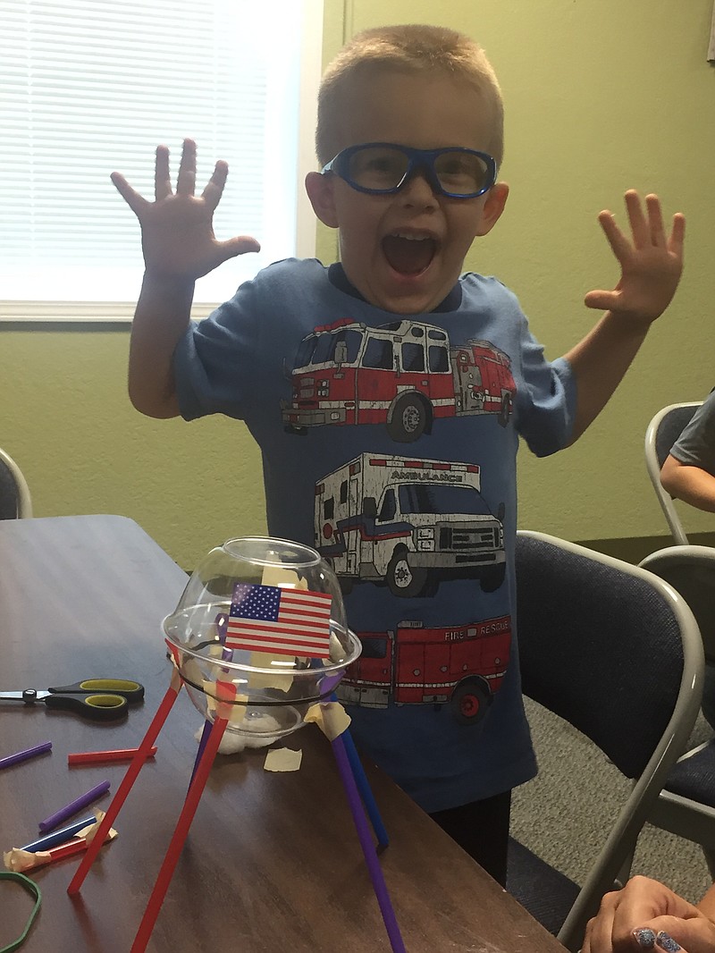 Karson Wieberg, 4, shows excitement after completing his mock lunar rover at the Moniteau County Library on Saturday, July 20, 2019. (Submitted photo)