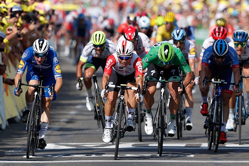 Australia's Caleb Ewan, center, sprints to win the sixteenth stage of the Tour de France cycling race over 117 kilometers (73 miles) with start and finish in Nimes, France, Tuesday, July 23, 2019. (AP Photo/ Thibault Camus)