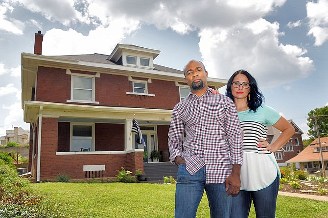 Aaron and Erin Clark pose outside of a home they own at 500 E. Miller St. The couple purchased the home in 2017 and now use it as a short-term rental unit known as the Hobo Hill House. The house and its spirits are the subject of an upcoming episode of "The Dead Files" that airs on the Travel Channel.