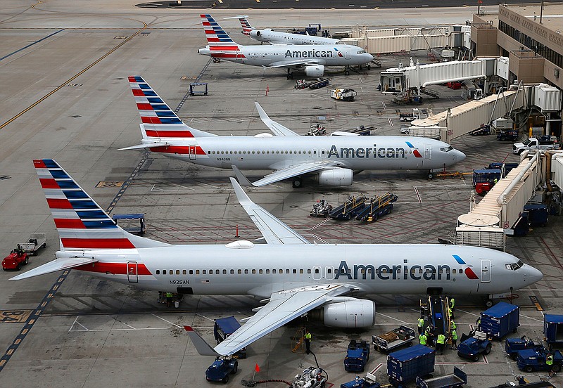 This  July 17, 2019 file photo shows American Airlines planes at Phoenix Sky Harbor International Airport in Phoenix.  An American Airlines flight attendant was bitten by an emotional support dog on a flight to North Carolina, requiring five stitches. WGHP reports the bite occurred Monday, July 22 on an Envoy Air-operated flight to Greensboro, N.C. (AP Photo/Ross D. Franklin)