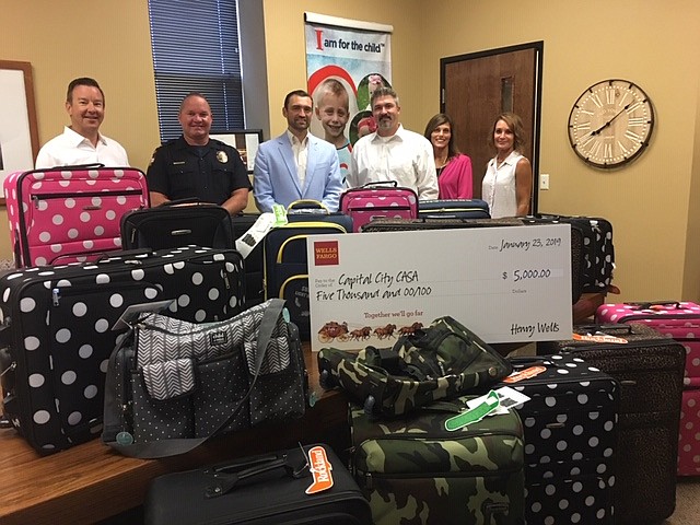 <p>Submitted photo</p><p>The Wells Fargo Foundation recently awarded Capital City Court Appointed Special Advocates a $5,000 grant. Pictured, from left, are Jon Rost of Wells Fargo Advisors, Eric Wilde of the Jefferson City Police Department, Chad Horton of Wells Fargo Advisors, Jay Carroll of Wells Fargo Advisors, Wanda Nierman of the Children’s Division and Capital City CASA Executive Director Gina Clement.</p>