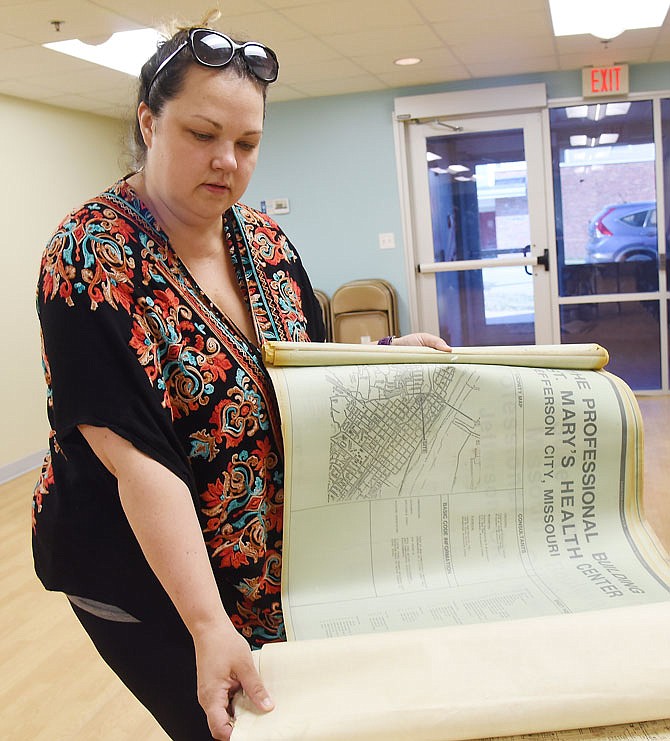 Historic City of Jefferson Executive Director Anne Greene shows architectural blueprints acquired from St. Mary's Hospital prior to its demolition. HCJ is now offering architectural salvage from historic and tornado-damaged historic buildings for sale. 
