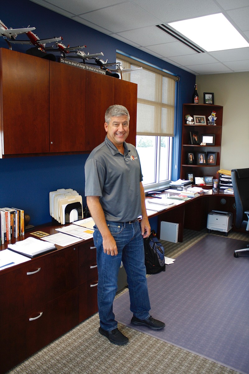 <p>Quinn Wilson/For the News Tribune</p><p>PFS Brands CEO Shawn Burcham stands in his office at PFS Brands’ headquarters in Holts Summit. Burcham’s book “Keeping Score with GRITT: Straight Talk Strategies for Success” will be released by ForbesBooks on Aug. 13.</p>