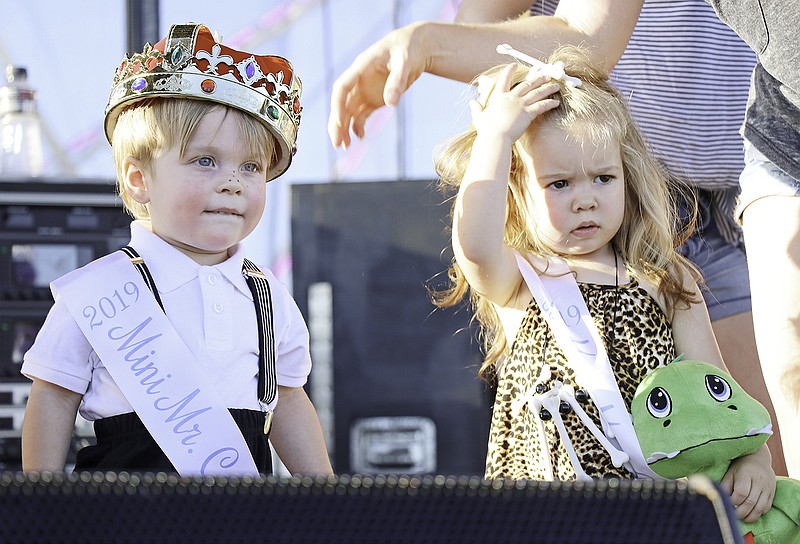 From left, 2019 Mini Mr. Cole County Camden Musso, 2, and Mini Miss Cole County Waylin Rowden, 2, of the 2-3 age division look out into the audience after being crowned Monday night at the Cole County Fair.
