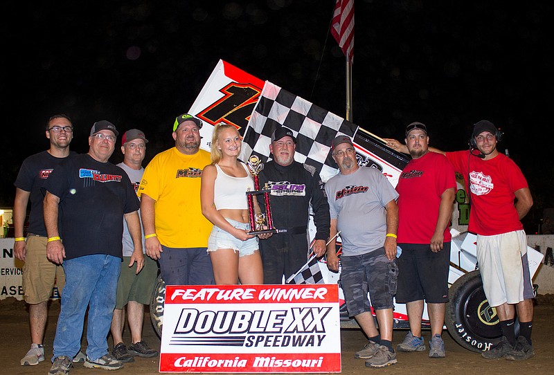 California's own Randy Martin raced his way into victory lane Sunday night at Double-X Speedway. Surrounded by team members and sponsors Martin is presented the hardware by Makayla Schanzmeyer, aided by Director of Competition A.J. Wirts both of California. (Photo courtesy of Carol Wirts)