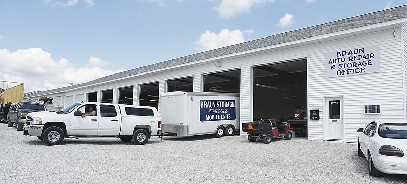 Julie Smith/News TribuneChris Carter pulls a portable storage trailer out of the garage at Braun Auto Repair as they prepare to start taking in vehicles for repair when they reopen Sunday. The garage was destroyed in the May 22 tornado and Doug Schrimpf Construction went to work to build the temporary garage so they could get the mechanics back to servicing vehicles. 