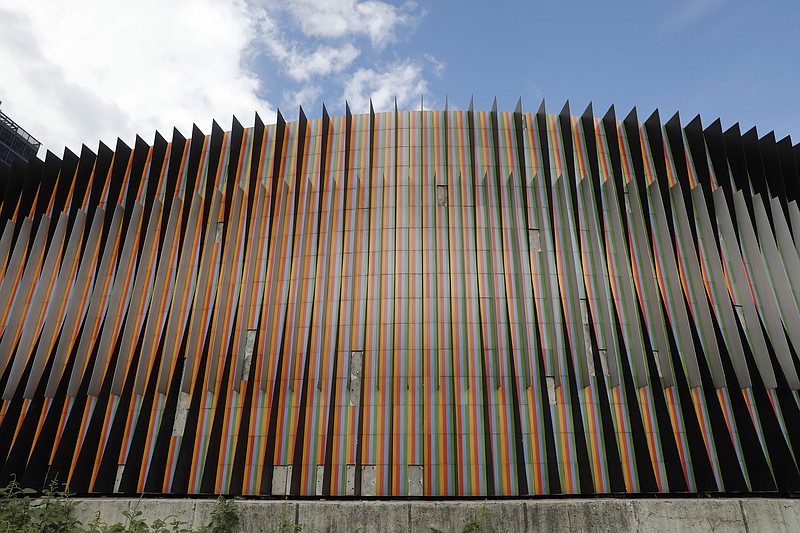 The masterpiece Fisicromía Concavo-Convexa, by Venezuela's master of kinetic art Carlos Cruz-Diez, stands in Caracas' Plaza Venezuela, Venezuela, Tuesday, July 30, 2019. As the art world mourns the death of Cruz-Diez, in his home country many of his urban works are deteriorating and disintegrating, even as the government pays lip service to his art. (AP Photo/Ariana Cubillos)