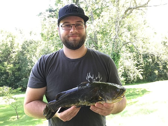 Cody Sparkman, of Perryville, holds his 2-pound, 13-ounce black bullhead caught on a jug line July 21, 2019, in Perry County.