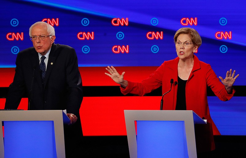 Sen. Bernie Sanders, I-Vt., and Sen. Elizabeth Warren, D-Mass., participate in the first of two Democratic presidential primary debates hosted by CNN Tuesday, July 30, 2019, in the Fox Theatre in Detroit. (AP Photo/Paul Sancya)