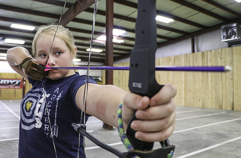 Greta Cross / News Tribune
Fifth-grader Sydney King prepares to shoot an arrow at Missouri Valley Archery and Outdoor’s archery range Thursday. King is a member of the Trinity Lutheran archery team and has been practicing the sport for about six months. In July, she took home second place in the elementary girls school division at the National Archery in the Schools Championship.