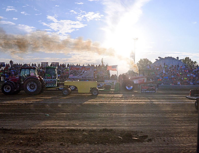 
Fans watch from the side Friday, August 2, 2019, as a Chevy truck competes in a MMTTPA truck and tractor pull during the Cole County Fair at the Jefferson City Jaycees Fairgrounds. Known as the world's heaviest motorsport truck and tractor pulls determine the strongest machine as well as the best driver.