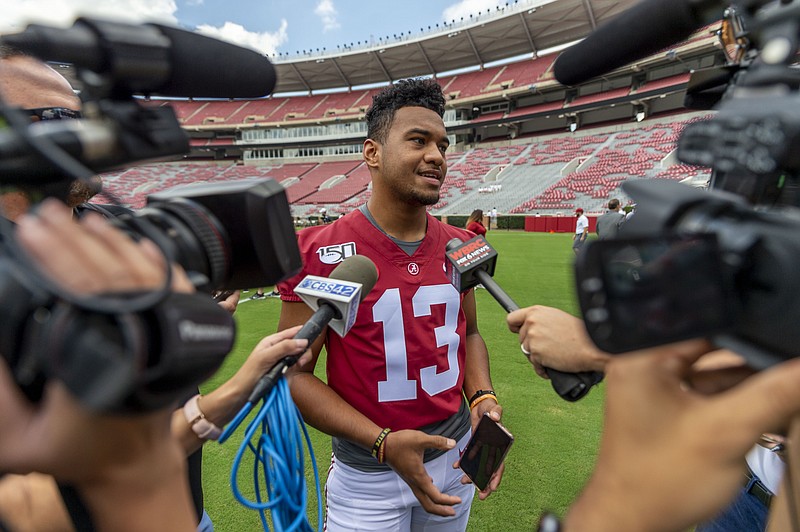 Alabama quarterback Tua Tagovailoa (13) talks with the media prior to Alabama's fall camp fan-day college football scrimmage, Saturday, Aug. 3, 2019, at Bryant-Denny Stadium in Tuscaloosa, Ala. (AP Photo/Vasha Hunt)