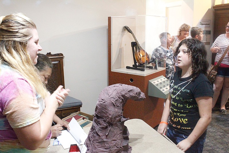 Alexis "Lexi" Wheeler stands before the Hogwarts House Sorting Hat on Saturday at the Texarkana Museum of Regional History. The Sorting Hat placed her in Slytherin. She wanted Gryffindor.