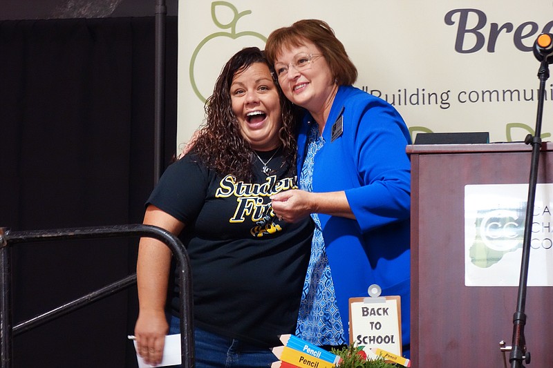 Kara Wilkerson, left, a special education teacher with Fulton Public Schools, celebrates with Callaway Bank CEO Kim Barnes after winning a cash giveaway at the second Annual Teacher Appreciation Breakfast. Teachers also received swag bags and other goodies.                               