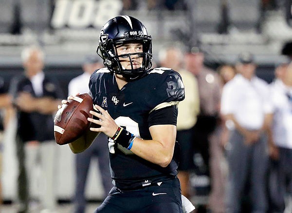 In this Sept. 21, 2018, file photo, Central Florida quarterback McKenzie Milton looks for a receiver during the first half of a game against Florida Atlantic in Orlando, Fla.