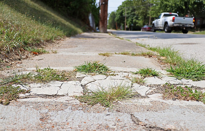 File photo: A sidewalk along High Street in Jefferson City is shown as cracked and uneven.