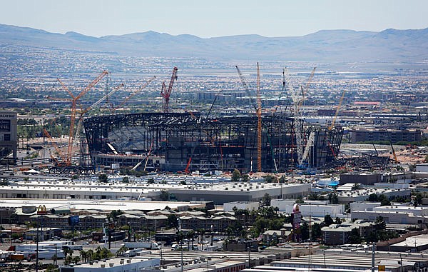 In this June 4 file photo, construction cranes surround the Raiders' football stadium under construction in Las Vegas.