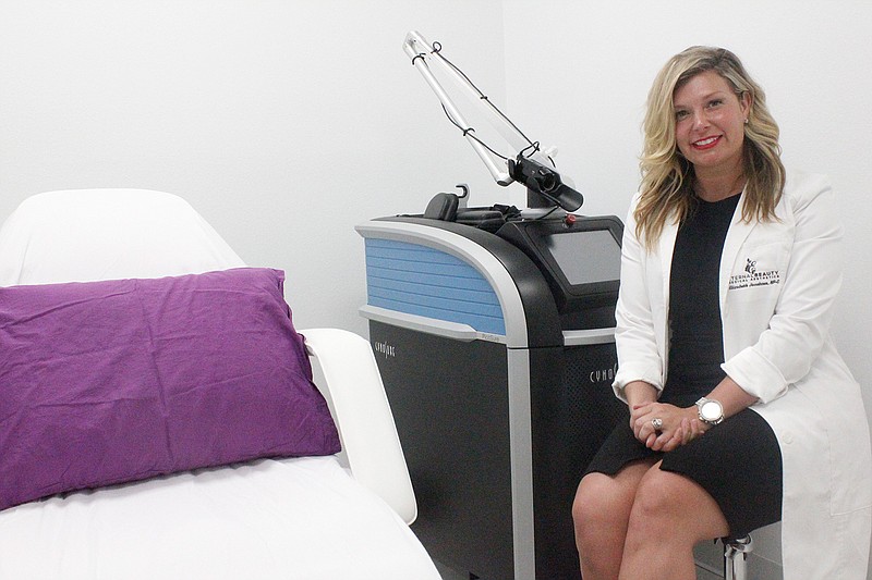 Elizabeth Jacobsen, owner and operator of Eternal Beauty, shows off one of the pieces of equipment in her facility. She emphasizes that her spa is built for comfort as well as modernity.