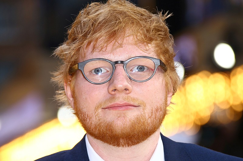In this June 18, 2019 file photo, singer Ed Sheeran poses for photographers upon arrival at the premiere of the film 'Yesterday' in London. Sheeran's Divide Tour is one for the record books. Pollstar confirms the 28-year-old British singer's tour set the all-time highest-grossing tour record with Friday, Aug. 2,  show in Hannover, Germany. Pollstar forecasts the total gross to this point of $736.7 million will top the previous record of $735.4 million set by U2 in 2011.(Photo by Joel C Ryan/Invision/AP, File)