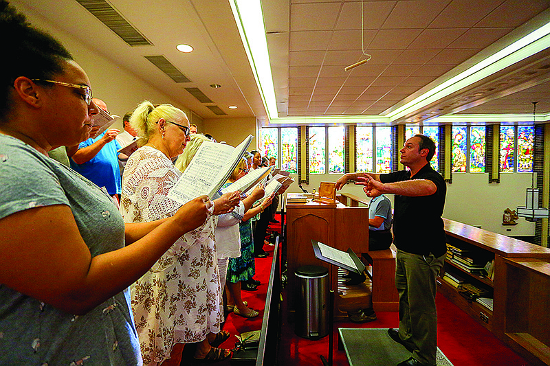 Members of the choir practice singing while Marc-Andre Bougie directs them at the Sacred Heart Catholic Church in Texarkana, Texas. Choir members spent the evening practicing for a performance of Mozart's "Coronation Mass" for an Orchestral Solemn High Mass that will be performed on Thursday. The Latin Mass involves sacred practices that have been performed for hundreds of years prior to 1969, when the Catholic Mass changed.