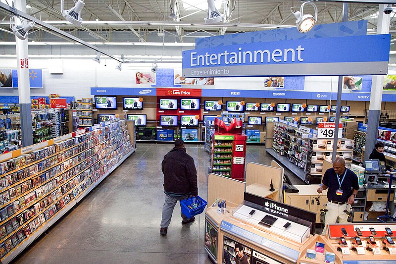 In this Dec. 15, 2010, file photo, a view of the entertainment section of a Wal-Mart store is seen in Alexandria, Va. Walmart is taking down all signs and displays from its stores that depict violence, following a mass shooting at its El Paso, Texas location that left 22 people dead. The retailer, according to an internal memo, instructed employees to turn off or unplug any video game consoles that show violent games, as well as ensure that no movies depicting violence are playing in its electronics departments.