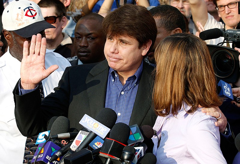 In this March 14, 2012, file photo, former Illinois Gov. Rod Blagojevich, with his wife Patti at his side, speaks to the media in Chicago before reporting to federal prison in Denver. President Donald Trump says he's "very strongly" considering commuting the sentence of Blagojevich, who is serving a 14-year prison term on multiple federal corruption convictions. Trump suggested more than a year ago that he was considering a commutation for Blagojevich, who then filed paperwork requesting a commutation. (AP Photo/M. Spencer Green, File)