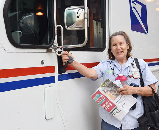 Long-time United States Postal Service carrier Joan Keth prepares to board her 2-ton van loaded with mail and parcels to be delivered Wednesday. Keth, who has worked for the post office for 35 years, will retire and the end of next week. 