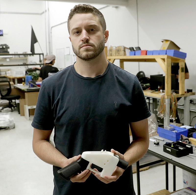 In this Aug. 1, 2018, file photo, Cody Wilson, with Defense Distributed, holds a 3D-printed gun called the Liberator at his shop, in Austin, Texas. On Friday, Aug. 9, 2019, Wilson, who sparked a nationwide legal fight over the constitutionality of firearms made with a 3D printer, pleaded guilty to having sex with an underage girl. (AP Photo/Eric Gay, File)