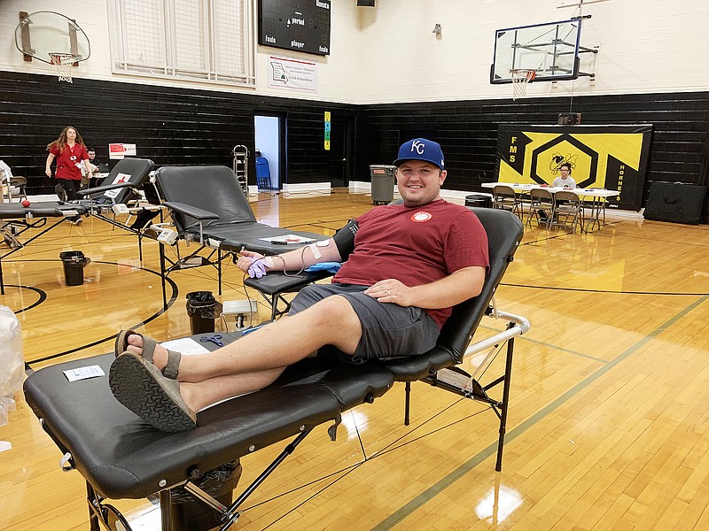 Fulton Middle School alum Travis Lane gives blood at Friday's emergency blood drive at FMS. Lane and his wife, Kylie Lane, said they try to participate in as many blood drives as they can.