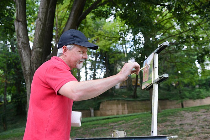 Artist Shawn Cornell, of St. Louis, paints with oils Saturday during a plein air painting session at the Jefferson Landing State Historic Site. Painters from around the state were invited to paint in the open air as they captured the summer scenery around the lawn of the Lohman Building and the Union Hotel. The outdoor activity was part of a soft opening for a plein air exhibit opening Tuesday at the Elizabeth Rozier Gallery