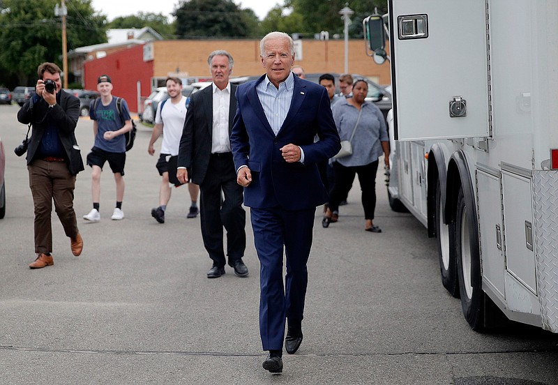 Former Vice President and Democratic presidential candidate Joe Biden runs into the building before speaking at the Iowa Democratic Wing Ding at the Surf Ballroom, Friday, Aug. 9, 2019, in Clear Lake, Iowa. (AP Photo/John Locher)