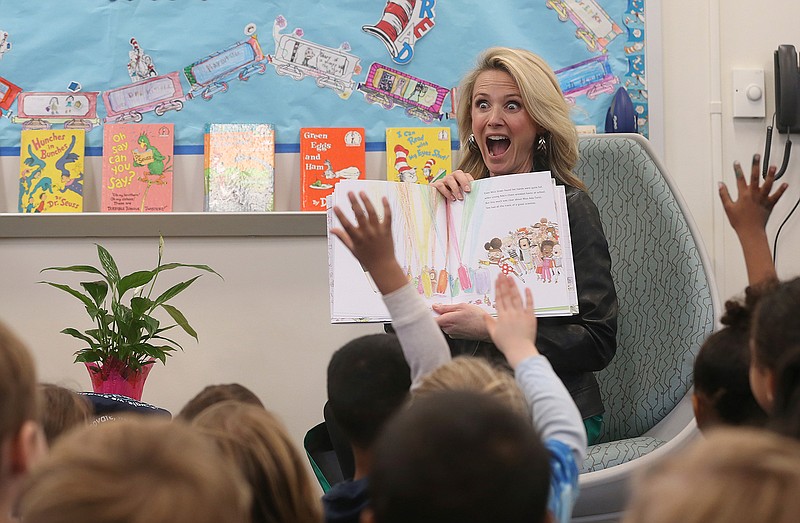 In this March 1, 2019 file photo first partner, Jennifer Siebel Newsom, the wife of Gov. Gavin Newsom, reads the book "Ada Twist, Scientist" by Andrea Beaty and David Roberts, to kindergarteners at the Washington Elementary School in Sacramento, Calif. Siebel Newsom visited the school, with her husband  to celebrate Read Across America Day. She often attends events with her husband but also works on issues of her own including equal rights for women. (AP Photo/Rich Pedroncelli, File)